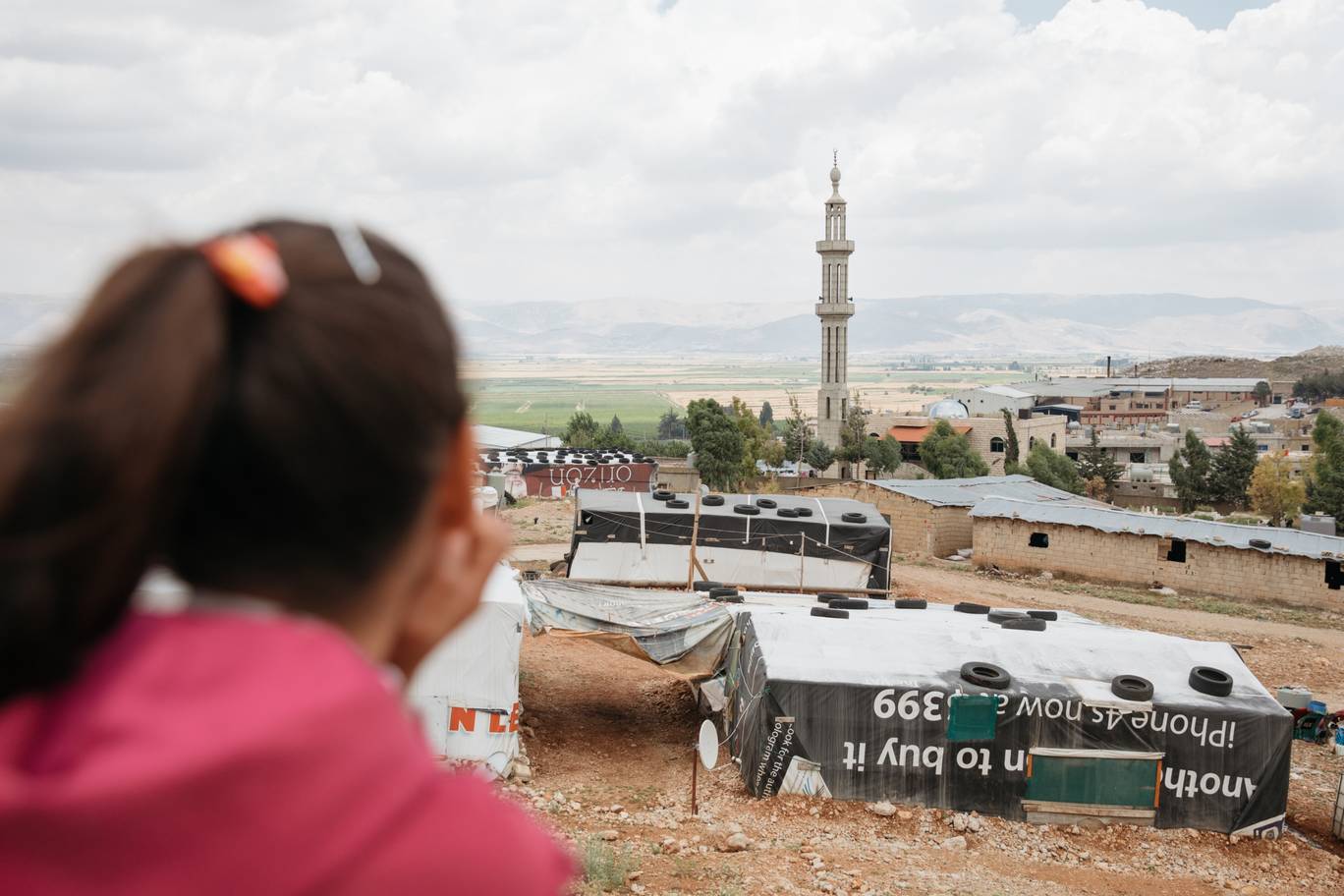 Behind the family tent is an old disused quarry where the Bedouins’ sheep graze the hard thistle plants. Sara can see across the Bekaa Valley to the mountains, beyond which is Syria and the distant memories of the old life they had - Photo by Paddy Dowling
