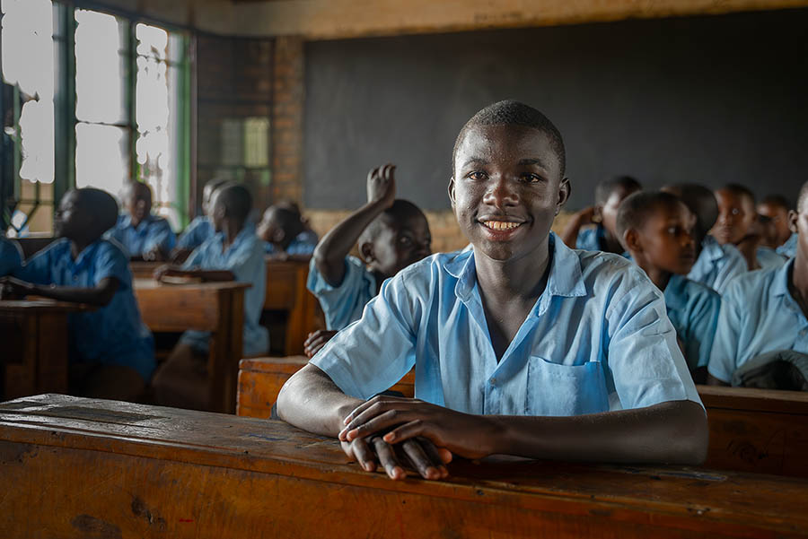 Boy in the classroom, smiling for the camera, Rwanda