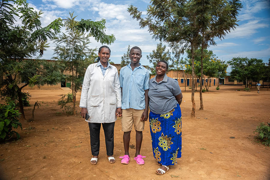 Three teachers in the school yard, work to find out of school children