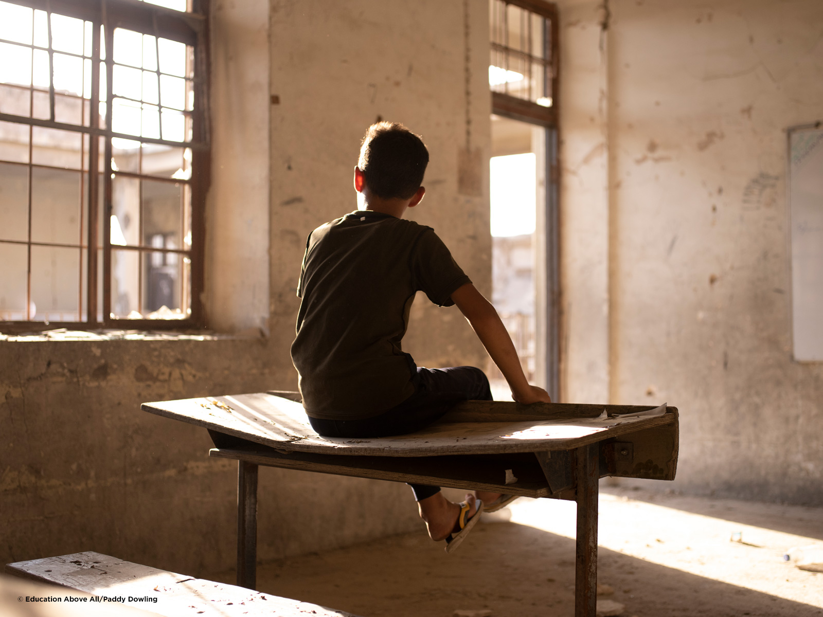 Boy in destroyed classroom, Mosul Iraq.  Photo: ©EAA/Padding Dowling